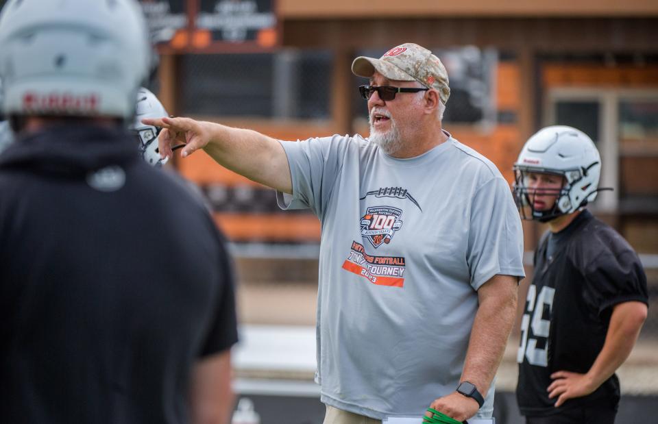 Washington head coach Darrell Crouch coaches his linemen on the official first day of high school football practice Monday, Aug. 7, 2023 at Washington Community High School.