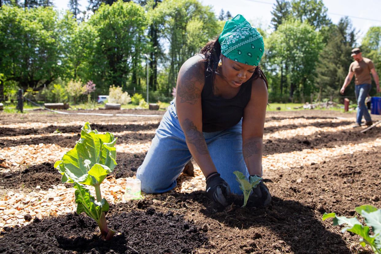 Kasha Brooks plants broccoli in Keizer at Black Joy Farms, a new community garden for people of color in need.