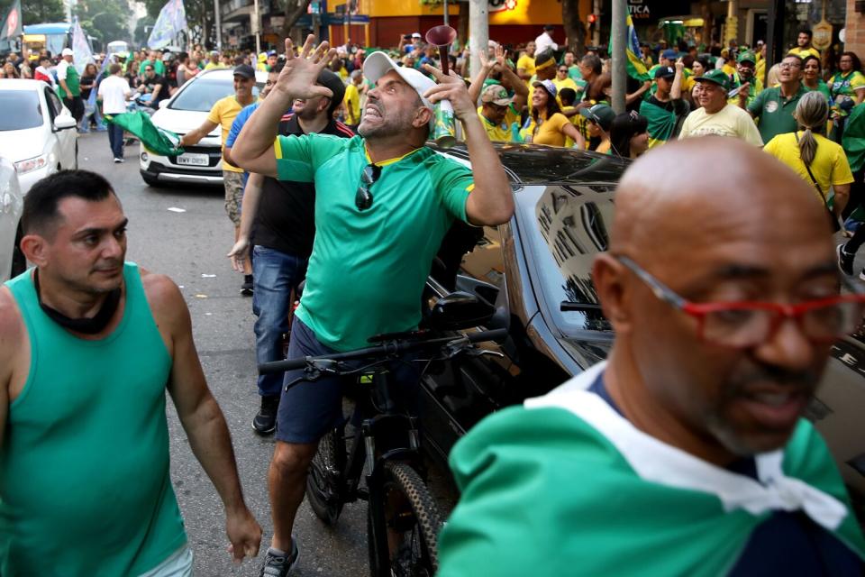 A supporter yells at someone standing on balcony.