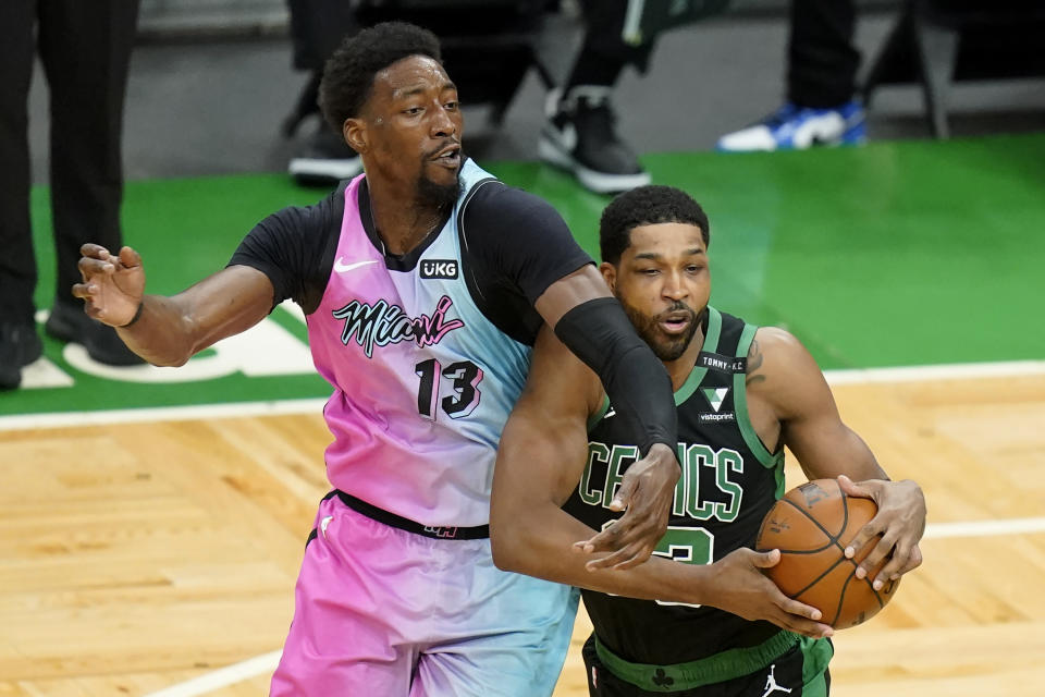 Miami Heat's Bam Adebayo, left, vies for control of the ball with Boston Celtics' Tristan Thompson, right, in the first half of a basketball game, Sunday, May 9, 2021, in Boston. (AP Photo/Steven Senne)