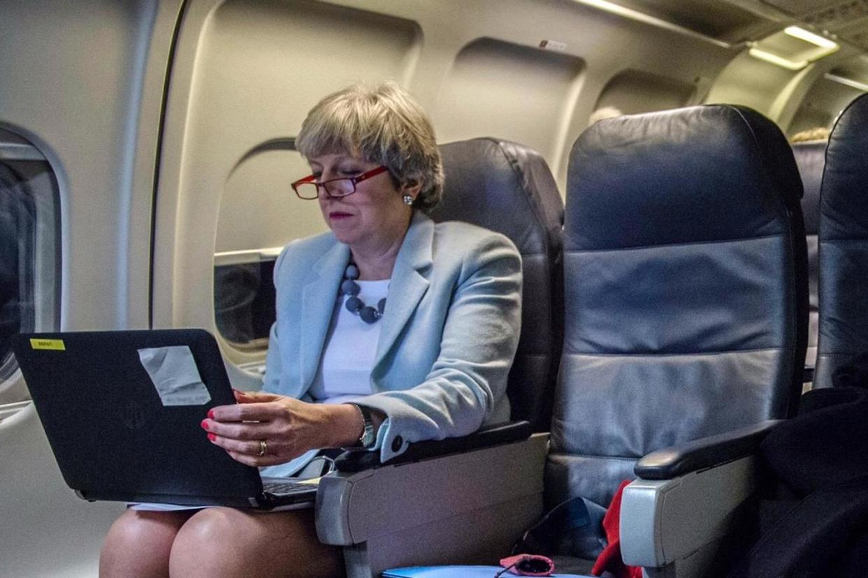 Theresa May working on her statement about the EU during a flight to Brussels: PA