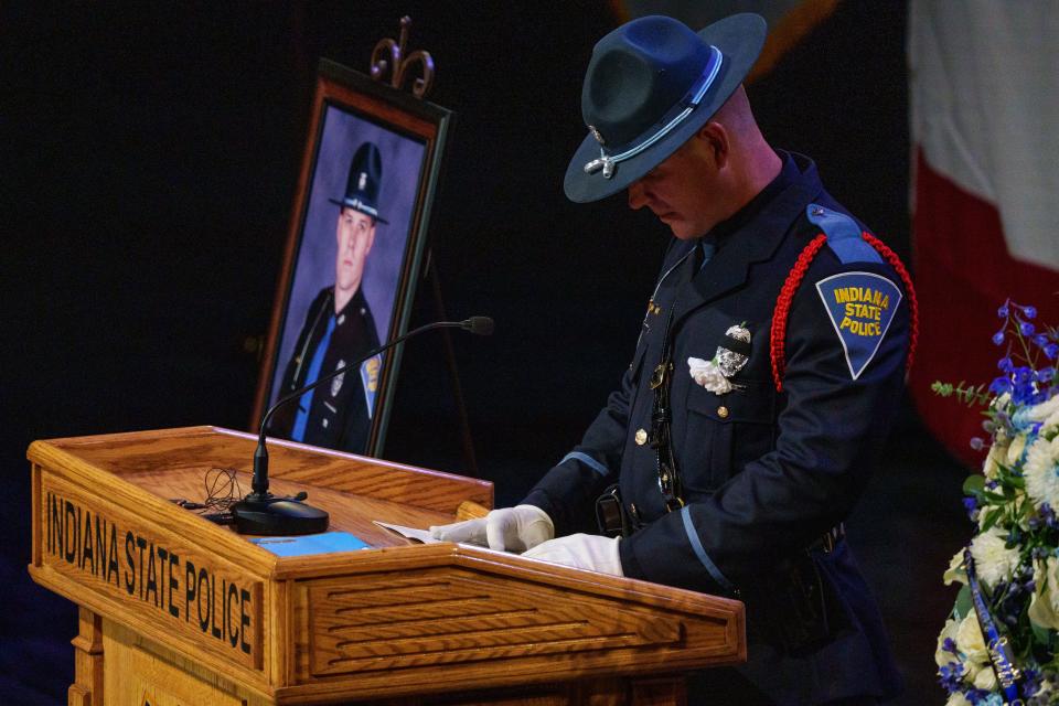Indiana State Police Trooper Cameron Bottema reads the obituary Friday, July 7, 2023, of fellow Indiana State Trooper Aaron N. Smith, 33, during Smith's funeral held at Emmanuel Church of Greenwood.