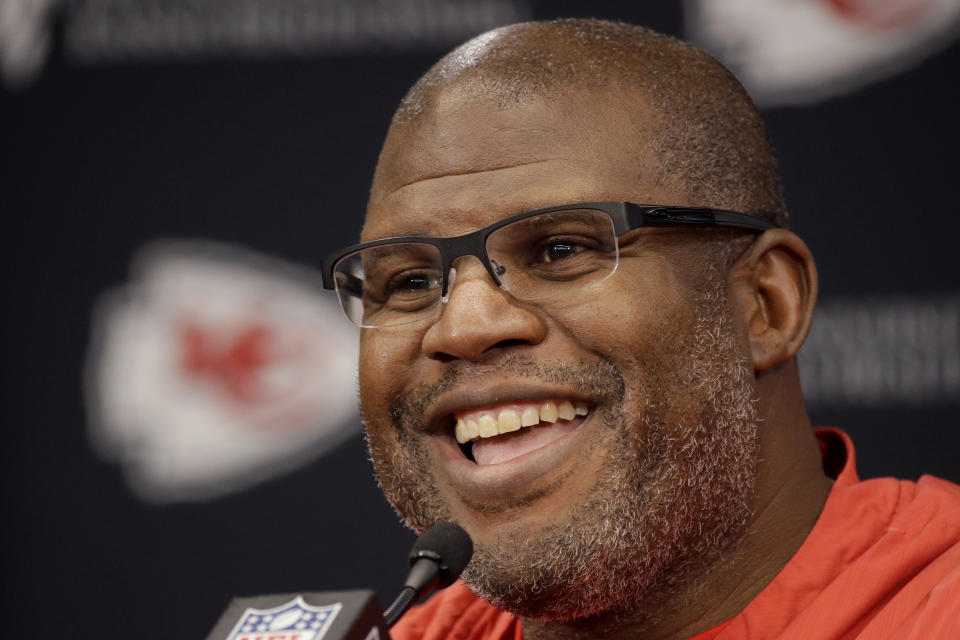 Eric Bieniemy smiles while answering questions during a Super Bowl media session.