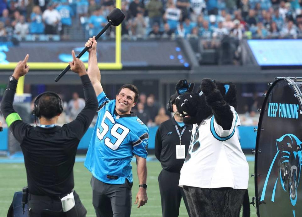 Former Carolina Panthers linebacker Luke Kuechly, center, acknowledges the cheers of the fans after hitting the Keep Pounding drum at Bank of America Stadium prior to the team’s game against the New Orleans Saints on Monday, September 18, 2023.