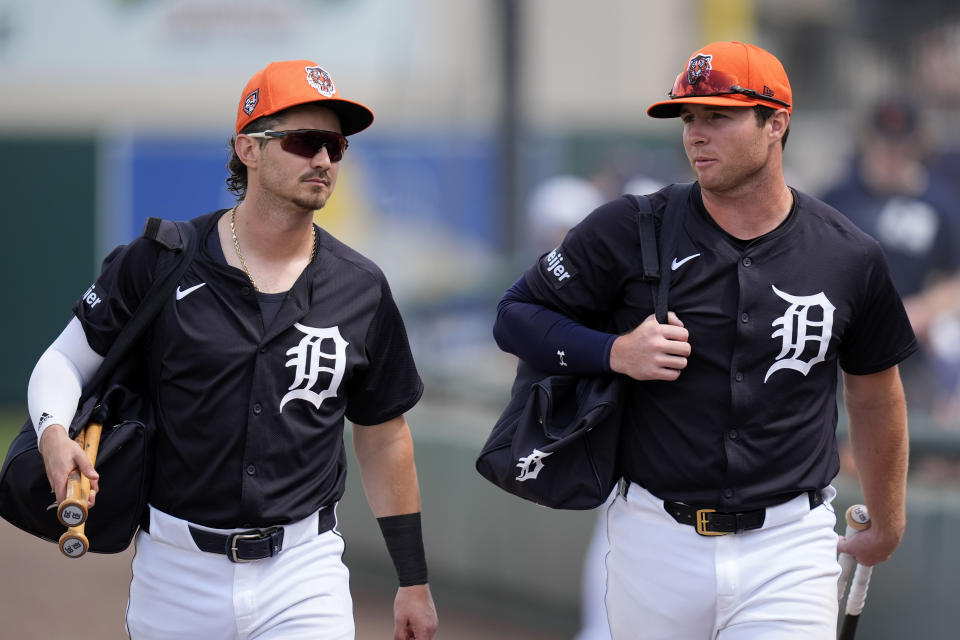 Detroit Tigers' Zach McKinstry, left, and Colt Keith walk to the field before a spring training baseball against the Pittsburgh Pirates game Saturday, March 9, 2024, in Lakeland, Fla. (AP Photo/Charlie Neibergall)