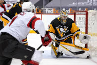 Pittsburgh Penguins goaltender Tristan Jarry (35) gloves a shot by New Jersey Devils' Yegor Sharangovich (17) during the second period of an NHL hockey game in Pittsburgh, Tuesday, April 20, 2021. (AP Photo/Gene J. Puskar)