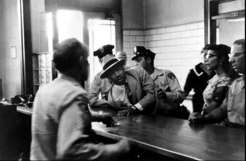 King's battle with the law continued. He was arrested thirty times for his participation in civil rights activities. Here he is being charged with loitering in 1958. (Charles Moore)