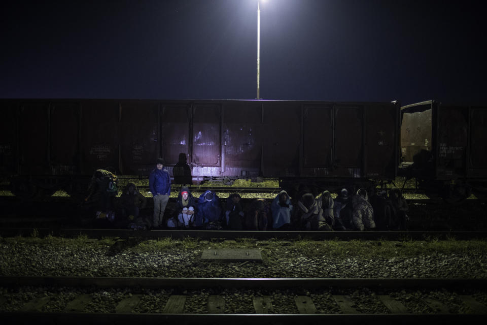 A group of migrants wait to be identified after being detained by Bosnian police around the the river Drina bordering between Bosnia and Serbia in the town of Karakaj, northeastern Bosnia on Dec. 16, 2019. (Photo: Manu Brabo/AP) 