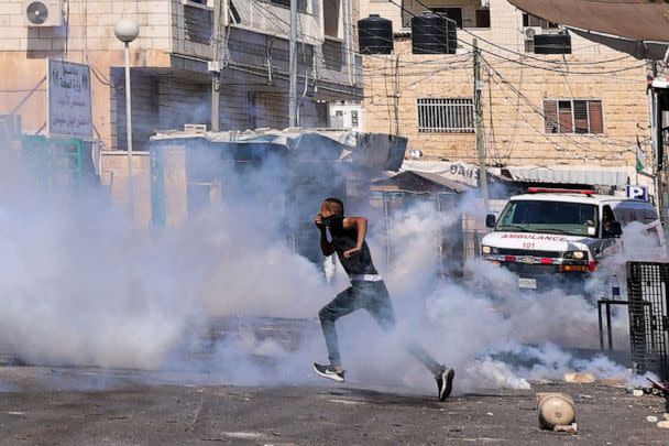 PHOTO: A man runs for cover after Israeli soldiers fired tear gas during an ongoing military operation in the occupied West Bank city of Jenin, July 4, 2023. (Jaafar Ashtiyeh/AFP via Getty Images)