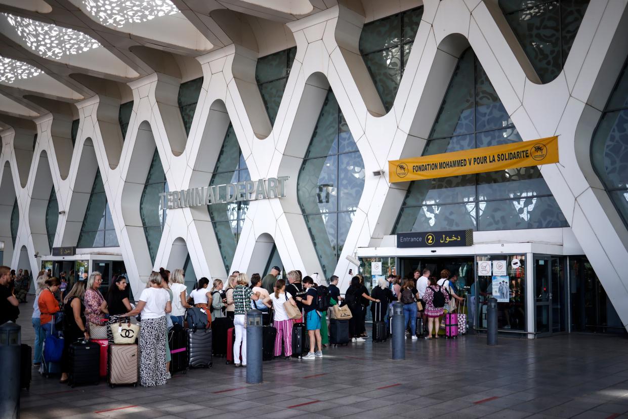 Tourists queue to enter the departures terminal at Marrakech airport (EPA)