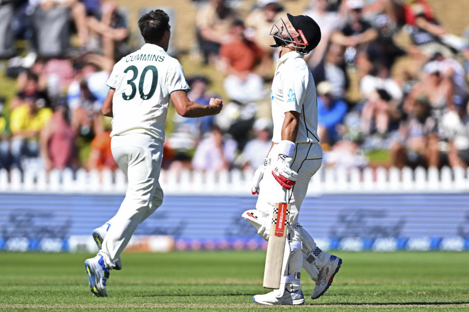 New Zealand's Daryl Mitchell, right, throws his head back after being caught out from the bowling of Australia's Pat Cummins, left, on the second day of their cricket test match in Wellington, New Zealand, Friday March 1, 2024. (Kerry Marshall/Photosport via AP)