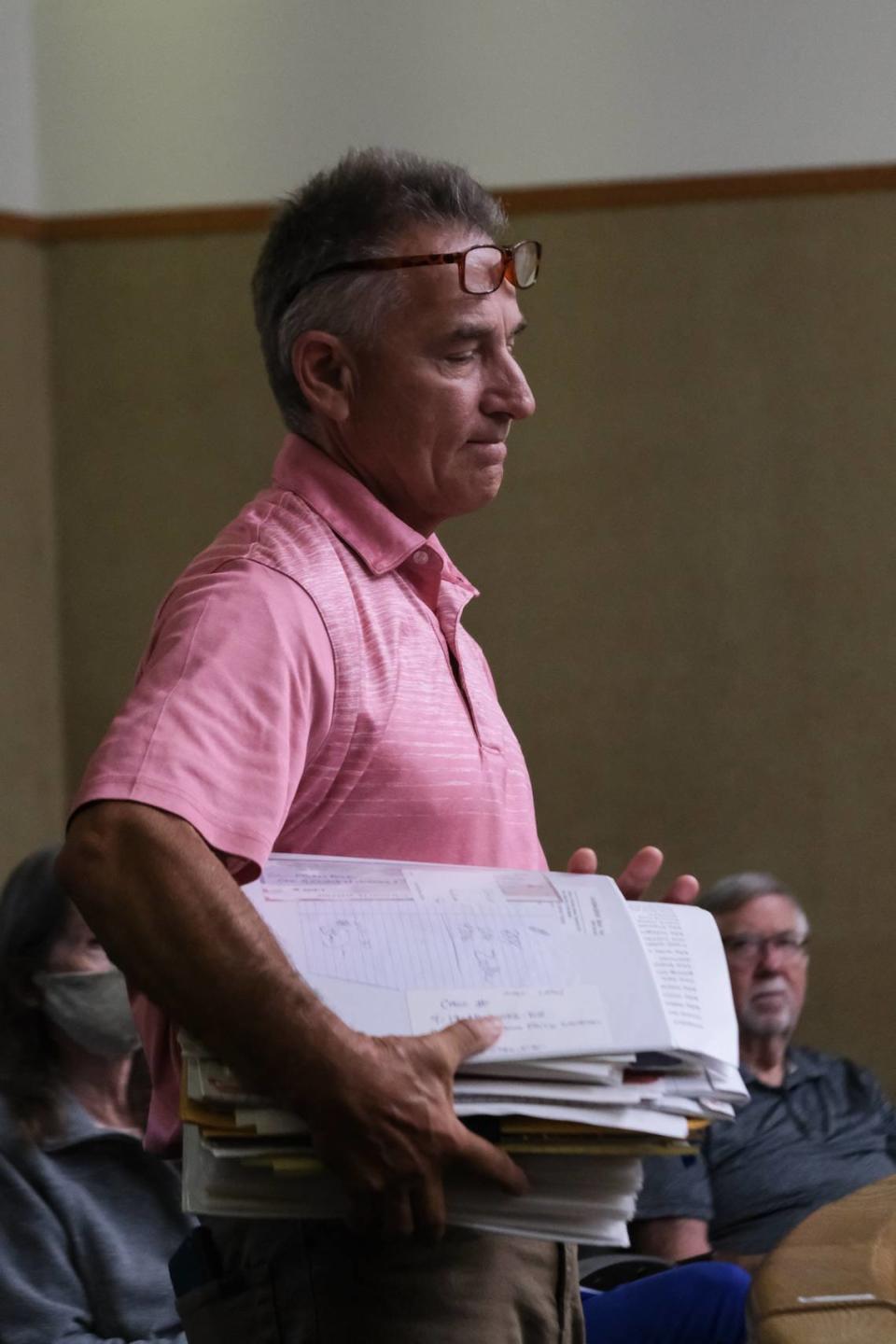 Kevin Rock holds his binder of evidence against Andrea Bowen-Gardner for financial crimes she committed while operating the consignment store Timeless Treasures, during her sentencing on June 10, 2024. She pleaded no contest to three felony counts of embezzlement and one felony count of writing a bad check.