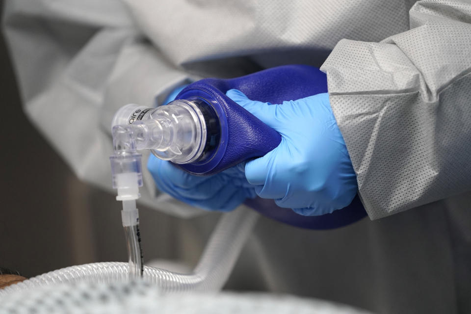 Air is pumped by hand as medical personnel try unsuccessfully to save the life of a patient inside the Coronavirus Unit at United Memorial Medical Center, Monday, July 6, 2020, in Houston. Hospitalizations due to COVID-19 in the second-largest state in the U.S. have more than doubled in the last two weeks. (AP Photo/David J. Phillip)