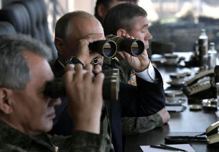 Russian President Vladimir Putin and Defence Minister Sergei Shoigu watch the Vostok-2018 (East-2018) war games at Tsugol military training ground in Zabaikalsky region, Russia, September 13, 2018. Sputnik/Alexei Nikolsky/Kremlin via REUTERS