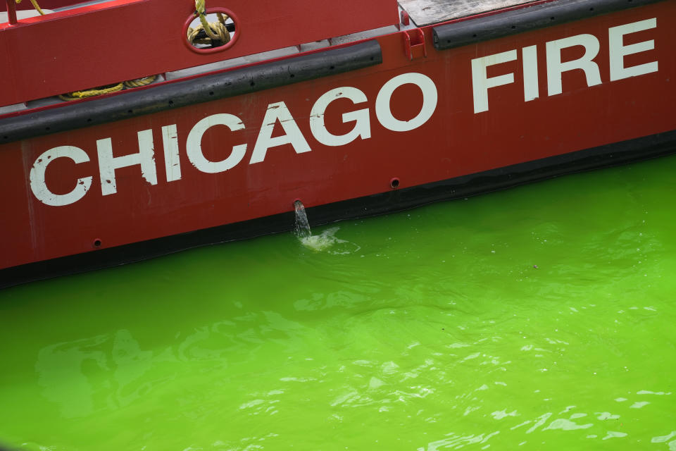 A Chicago Fire Department boat floats on the Chicago River, dyed green ahead of St. Patrick's Day celebrations, Saturday, March 16, 2024, in Chicago. (AP Photo/Erin Hooley)