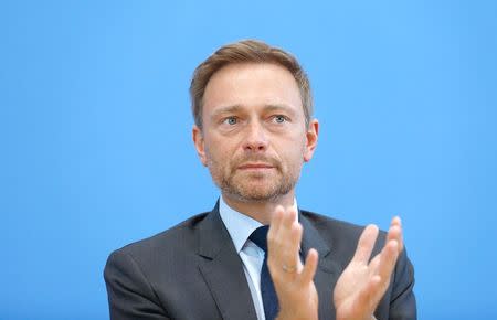 FILE PHOTO: Christian Lindner, chairman of the liberal Free Democratic Party (FDP) addresses a news conference after the regional state elections of North Rhine-Westphalia, in Berlin, Germany, May 15, 2017. REUTERS/Pawel Kopczynski