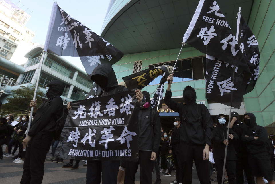 Hong Kong protesters and Taiwanese supporters gather, holding slogan to demand the release of the 12 Hong Kong protesters that have been arrested by mainland Chinese authorities, in Taipei, Taiwan, Sunday, Oct. 25, 2020. A group of 12 people from Hong Kong were allegedly traveling illegally by boat to Taiwan in August when Chinese authorities captured them and detained them.(AP Photo/Chiang Ying-ying)