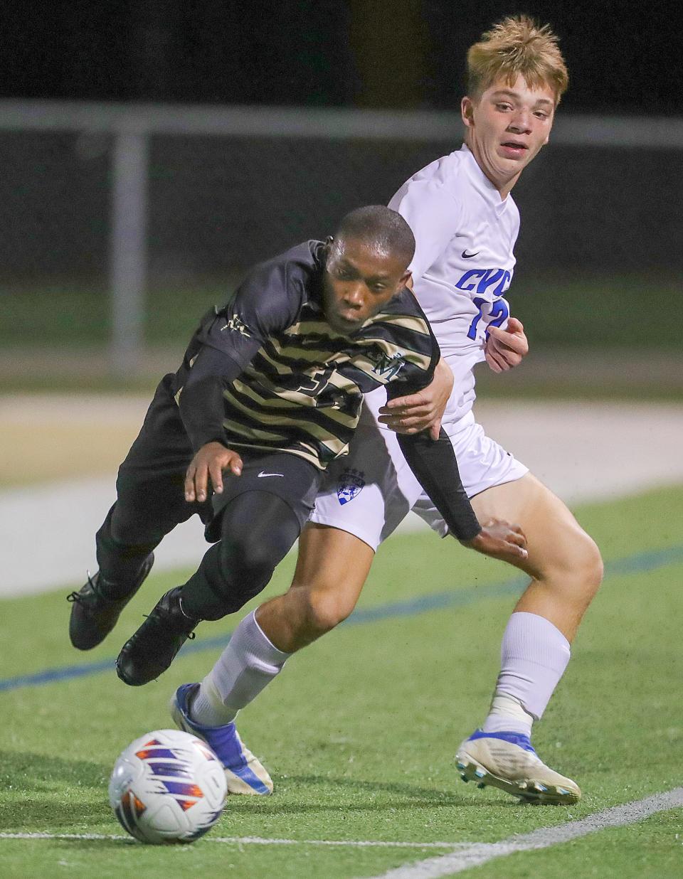 St. Vincent-St. Mary defender Raylen McCray is tripped up by CVCA's Tyson Linaburg on Thursday, Sept. 21, 2022 in Akron.