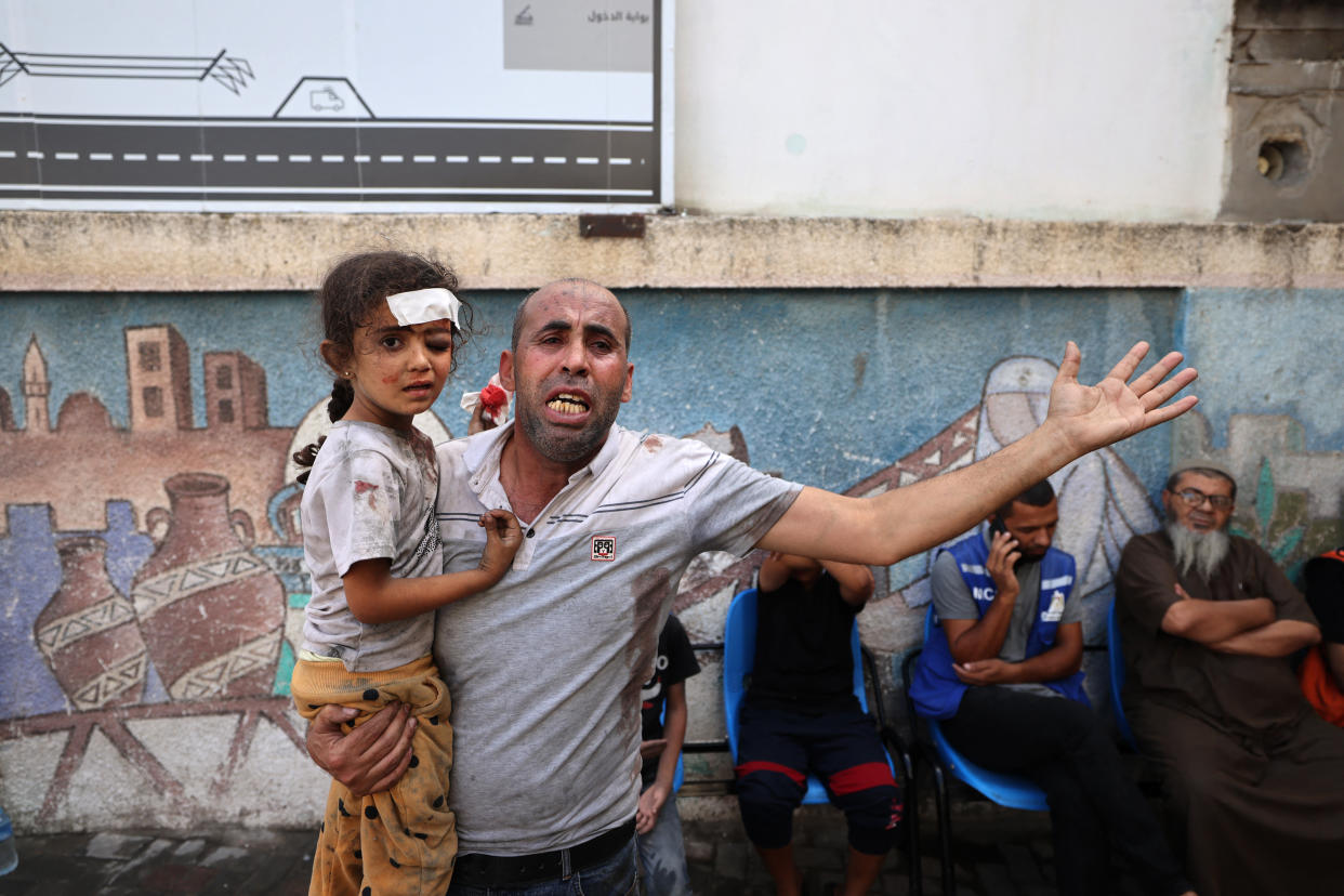 A Palestinian man holds an injured girl following an Israeli airstrike on Rafah in the southern Gaza Strip on Tuesday.