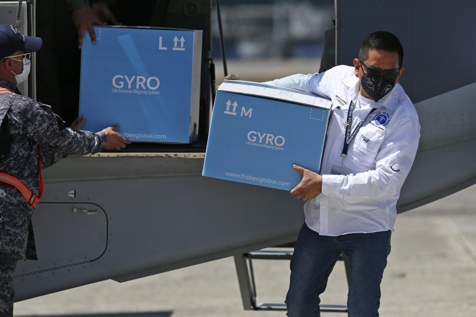 Workers unload boxes of Moderna COVID-19 vaccines and supplies donated by Israel at an Air Force base in Guatemala City, Thursday, Feb. 25, 2021. (AP Photo/Moises Castillo)