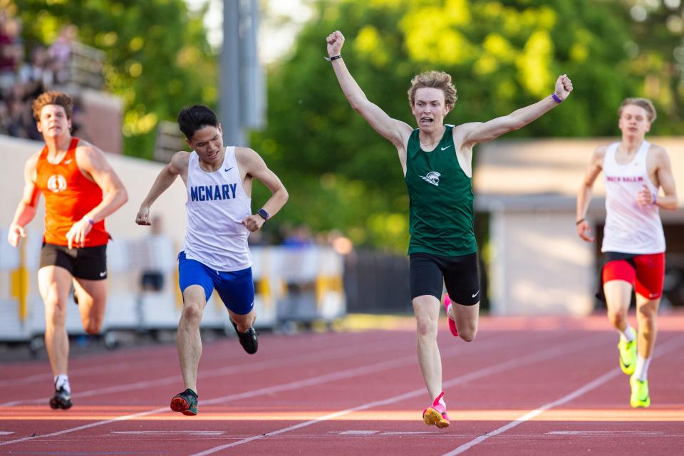 McNary's Pawat Potisuk, left, leans to beat West Salem's Jerett Peil in the 400 meters during the CVC Track and Field District Championships at McCulloch Stadium on Friday, May 10, 2024, in Salem.