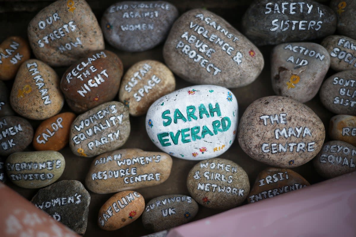 Tributes paid to Sarah Everard at Clapham Common vigil: Stones with signatures on them lie at a memorial site at the Clapham Common Bandstand (Reuters)