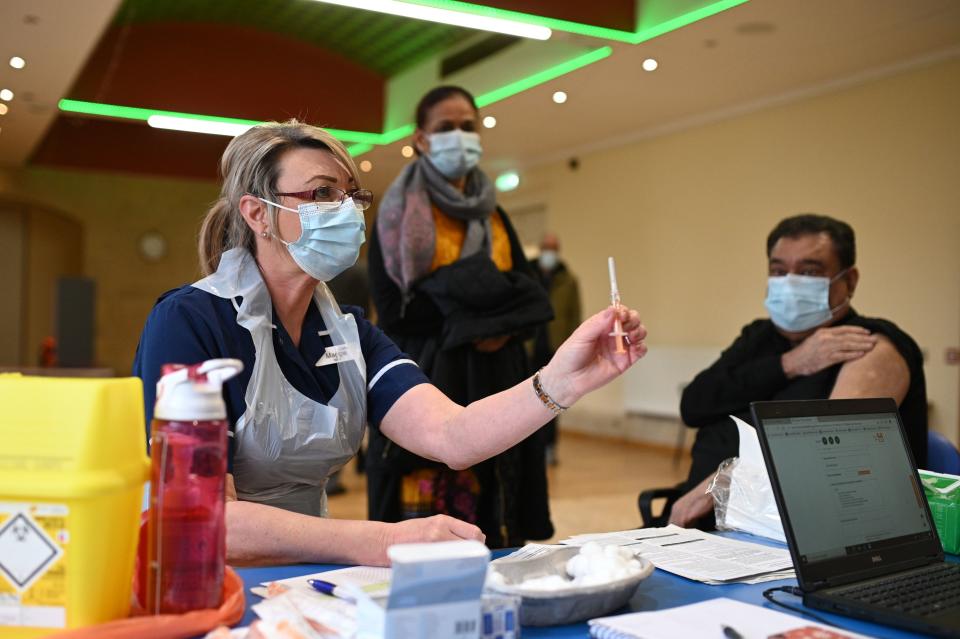 Nurse Maggie Clark prepares to administer a dose of the AstraZeneca/Oxford Covid-19 vaccine to a patient at a vaccination centre set up at the Fiveways Islamic Centre and Mosque in Nottingham, central England, on February 22, 2021. - Coronavirus vaccines do not contain pork or make you infertile: a celebrity advertising pitch is striving to counter a worrying lag among certain ethnic minorities affecting Britain's otherwise impressive inoculation campaign. (Photo by Oli SCARFF / AFP) (Photo by OLI SCARFF/AFP via Getty Images)