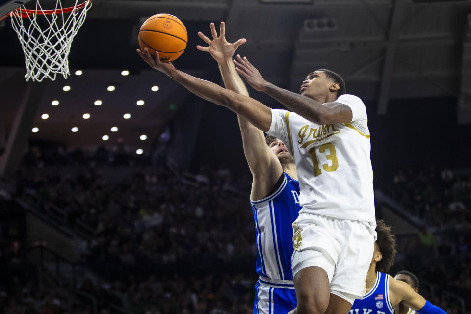 Notre Dame's Tae Davis (13) shoots next to Duke's Ryan Young during the second half of an NCAA college basketball game Saturday, Jan. 6, 2024, in South Bend, Ind. (AP Photo/Michael Caterina)