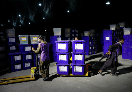 Afghan election commission workers prepare ballot boxes and election material to send to the polling stations at a warehouse in Kabul, Afghanistan October 18, 2018.REUTERS/Mohammad Ismail