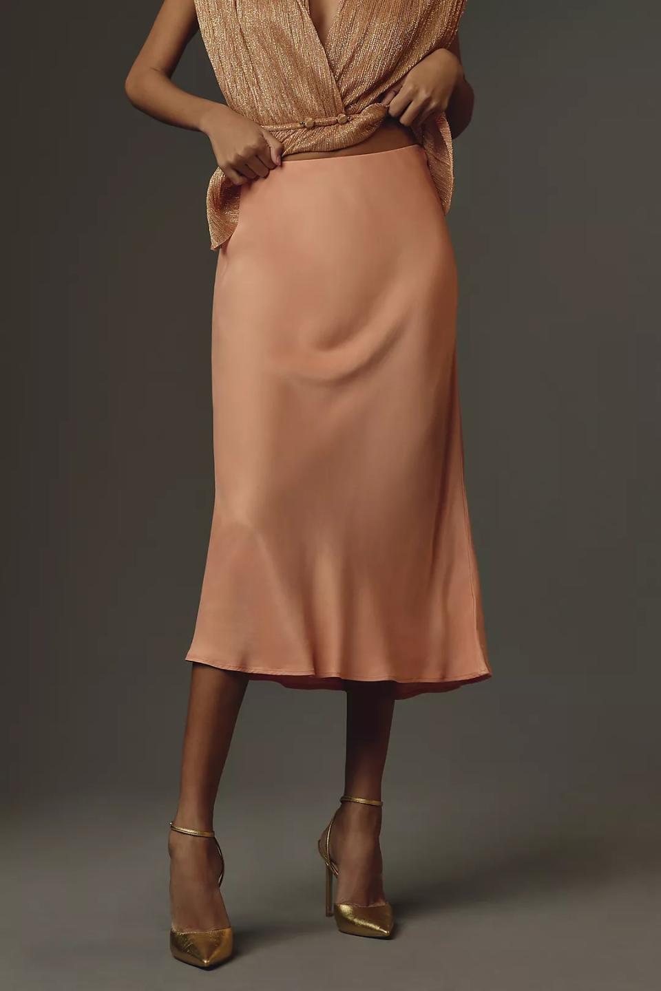 model wearing peach slip skirt with sparkly blouse