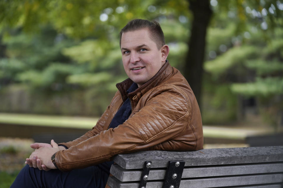 Opera singer Ilya Silchukou sits for a photograph at a park in a suburb of Boston, Tuesday, Oct. 4, 2022. Silchukou was a cultural icon in his native Belarus, the lead soloist at the State Opera Bolshoi who represented his nation at official government functions at home and abroad and performed at opera houses all over Europe. He lived a privileged and comfortable life in his homeland, but gave it up after joining tens of thousands of Belarusians at election protests that were violently suppressed by the Lukashenko government. (AP Photo/Steven Senne)