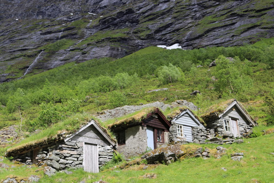 This June 5, 2019 photo shows old farmhouses with grass-covered roofs along a road near Hellesylt, Norway. A trip on a cruise ship in spring and summer provides a close view of the high cliffs that tower over the narrow inlets. Unlike cruises that spend long periods at sea between ports, a trip through Norway’s fjords provides ever-changing scenery, with no need for a strenuous hike. (AP Photo/Brian Witte)