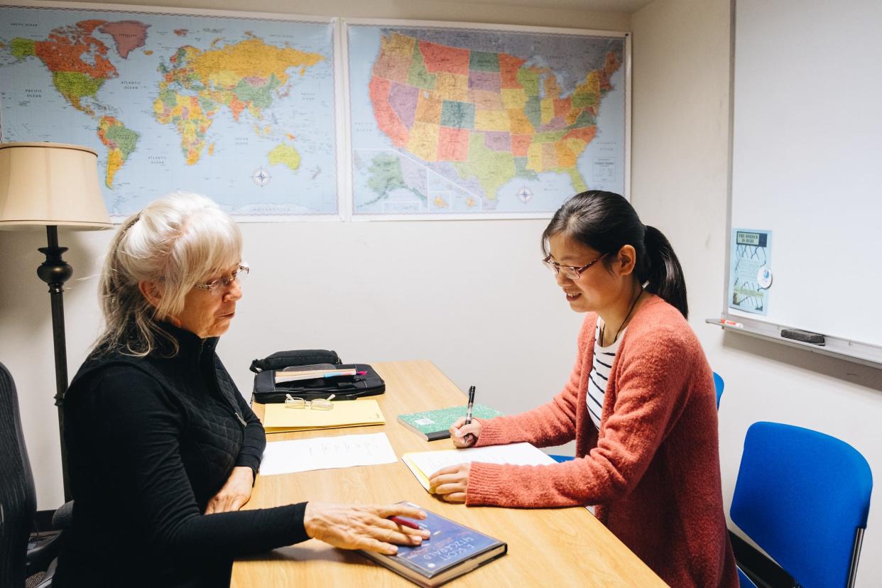 Volunteer tutor Patsy Rahn and adult learner Jianhong Wu discuss the book "The Great Gatsby" in a one-on-one tutoring session.