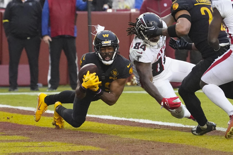 Washington Commanders cornerback Kendall Fuller (29) makes an interception against Atlanta Falcons running back Cordarrelle Patterson (84) during the second half of an NFL football game, Sunday, Nov. 27, 2022, in Landover, Md. Washington won the game 13-19. (AP Photo/Alex Brandon)