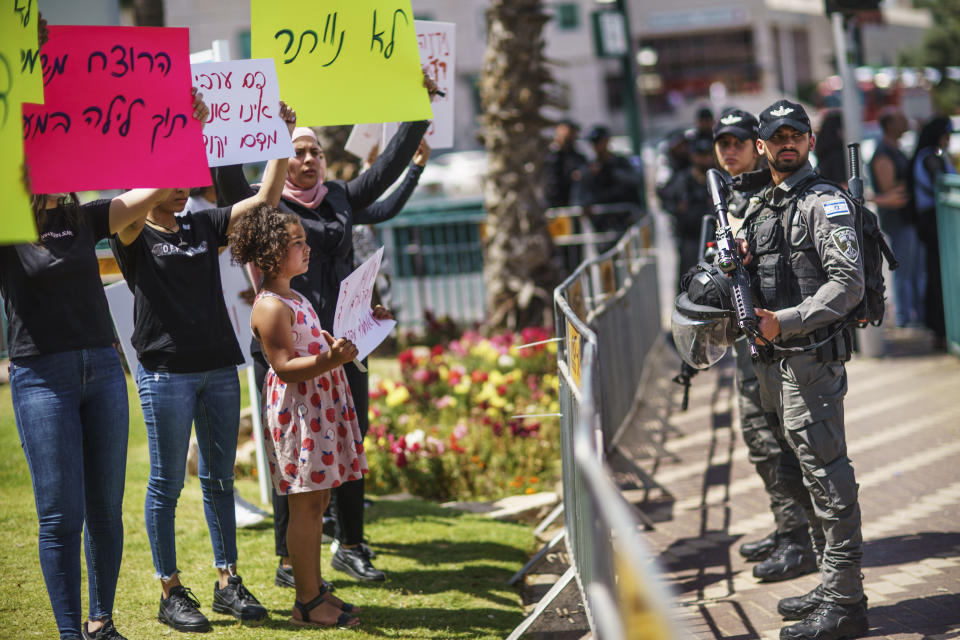 Police stand by during a demonstration calling for justice in the killing of Musa Hassuna in the mixed Arab-Jewish town of Lod, central Israel, Friday, May 28, 2021. Hassuna, an Israeli Arab, was shot and killed May 11 by Jewish suspects during the first night of unrest in Lod. The suspects have been released on bail and claim they acted in self-defense. Arab residents of Lod dispute the account, pointing out that the slain man was unarmed. (AP Photo/David Goldman)