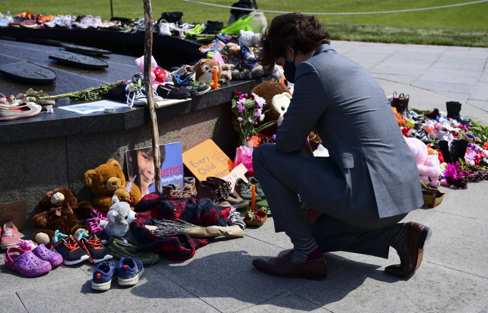 FILE - In this June 1, 2021, file photo, Canadian Prime Minister Justin Trudeau visits a memorial at the Eternal Flame on Parliament Hill in Ottawa that's in recognition of discovery of children's remains at the site of a former residential school in Kamloops, British Columbia. Leaders of Indigenous groups in Canada say investigators have found more than 600 unmarked graves at the site of a former residential school for Indigenous children in Saskatchewan. That follows last month's discovery of about 215 bodies at another such school in British Columbia. (Sean Kilpatrick/The Canadian Press via AP, File)