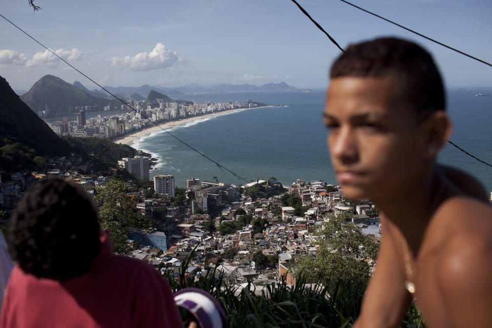Ipanema beach, top, is seen from the Vidigal shantytown in Rio de Janeiro, Brazil, Tuesday, May 22, 2012. Local officials and human rights groups are working to give legal title to tens of thousands of residents of shantytowns, a process that increases their wealth and gives them greater access to credit, as well as peace of mind. The programs so far are just a start at tackling a widespread problem: A third of the people in Rio state, nearly 5 million people, don't have title to their homes, an uncertainty shared by most of the approximately 1 billion people who living in slums globally. (AP Photo/Felipe Dana)