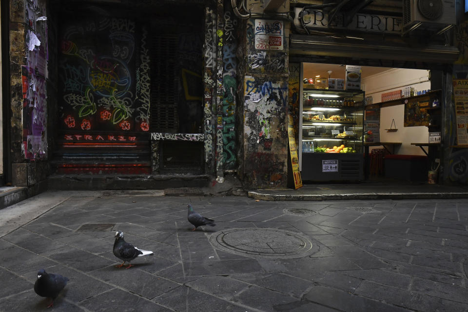 A cafe open for take away is seen in Centre Place in Melbourne, Australia Monday, Aug. 3, 2020. Australia’s hard-hit Victoria state was declared a disaster with sweeping new coronavirus restrictions imposed across Melbourne and elsewhere from Sunday night. (James Ross/AAP Image via AP)