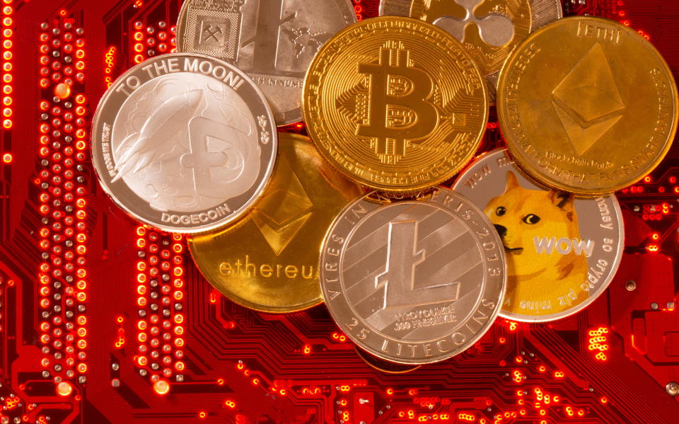 Representations of cryptocurrencies Bitcoin, Ethereum, DogeCoin, Ripple, Litecoin are placed on PC motherboard in this illustration taken, June 29, 2021. REUTERS/Dado Ruvic/Illustration