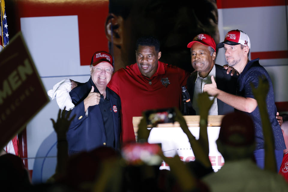 FILE - Sen. Lindsay Graham, R-S.C., from left to right, Herschel Walker, Republican candidate for U.S. Senate in Georgia, former United States Secretary of Housing and Urban Development Ben Carson, and radio host Clay Travis pose for a photo at the end of a rally in Kennesaw, Ga., Monday, Nov. 7, 2022. Walker is in a runoff election with incumbent Democratic Sen. Raphael Warnock. (Miguel Martinez/Atlanta Journal-Constitution via AP, File)