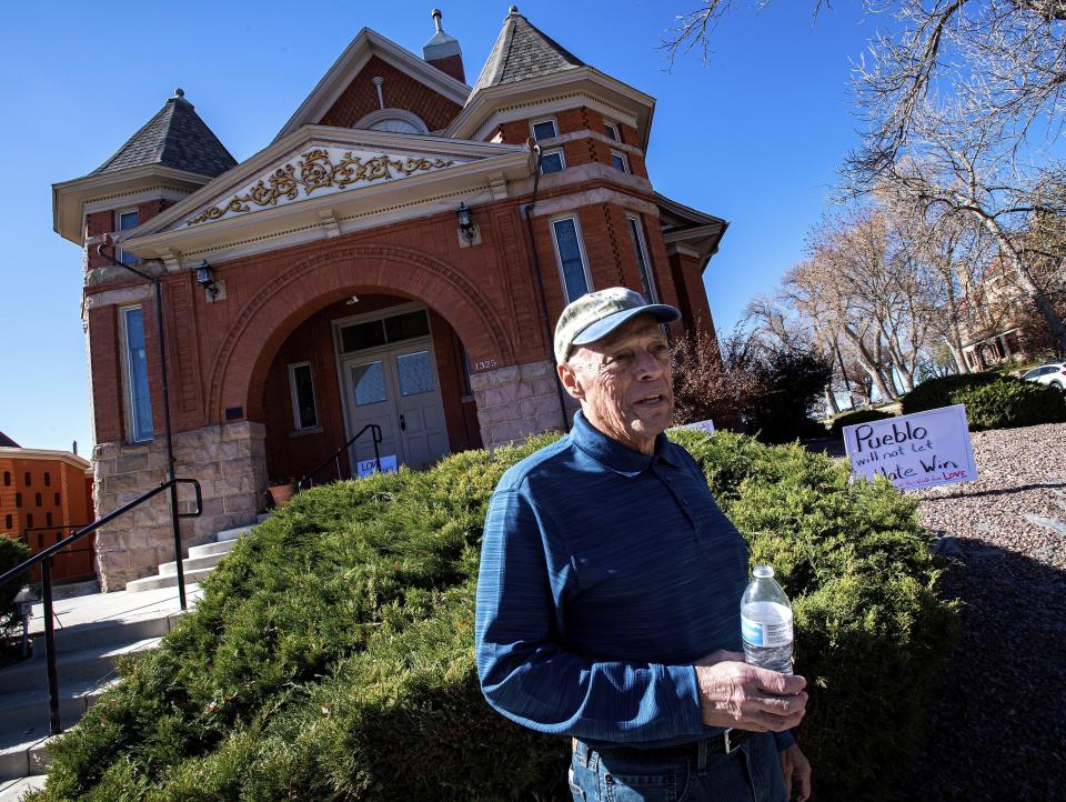 FILE - In this Nov. 5, 2019, file photo, Temple president Michael Atlas-Acuña found signs, flowers and candles expressing love for the Jewish community when he arrived at the historic Temple Emanuel in Pueblo, Colo. Richard Holzer, 28, a man described by federal prosecutors as a neo-Nazi and white supremacist, pleaded guilty Thursday, Oct. 15, 2020, to a hate crime for plotting to bomb the historic Colorado synagogue last year. (Christian Murdock/The Gazette via AP, File)