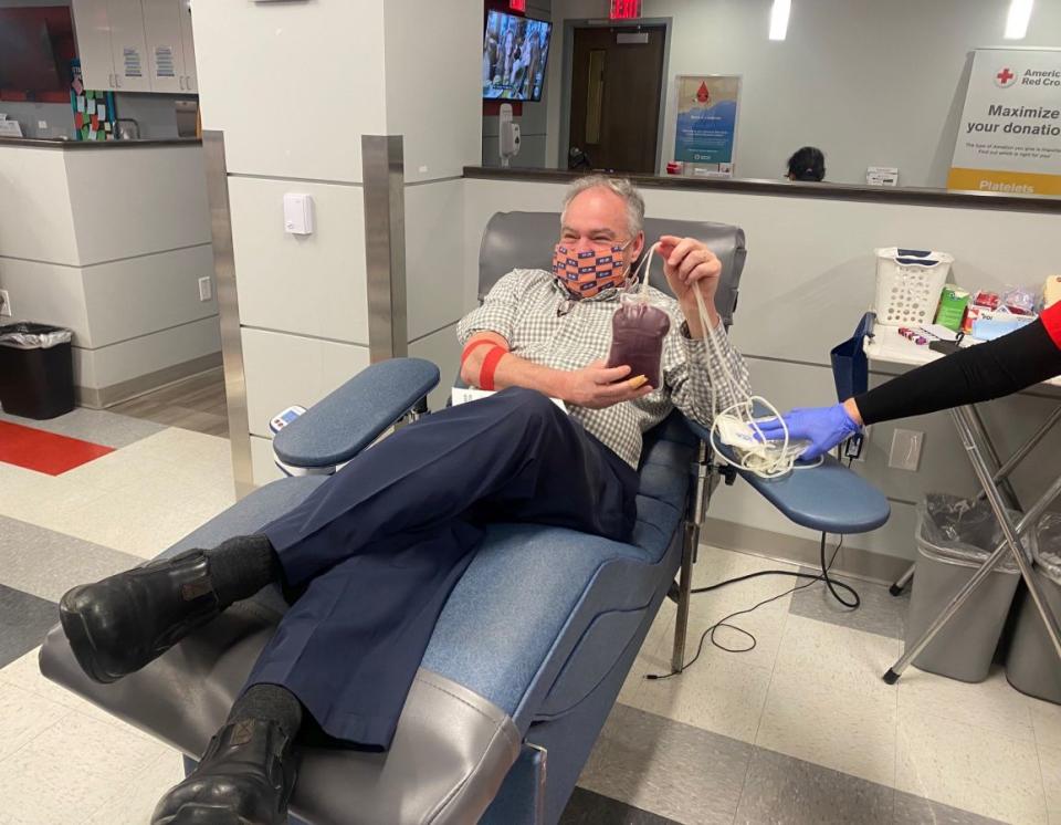 U.S. Sen. Tim Kaine (D-VA) displays the unit of blood he donated Friday morning at an American Red Cross donation center in Fairfax County. (Mark Hand/Patch)