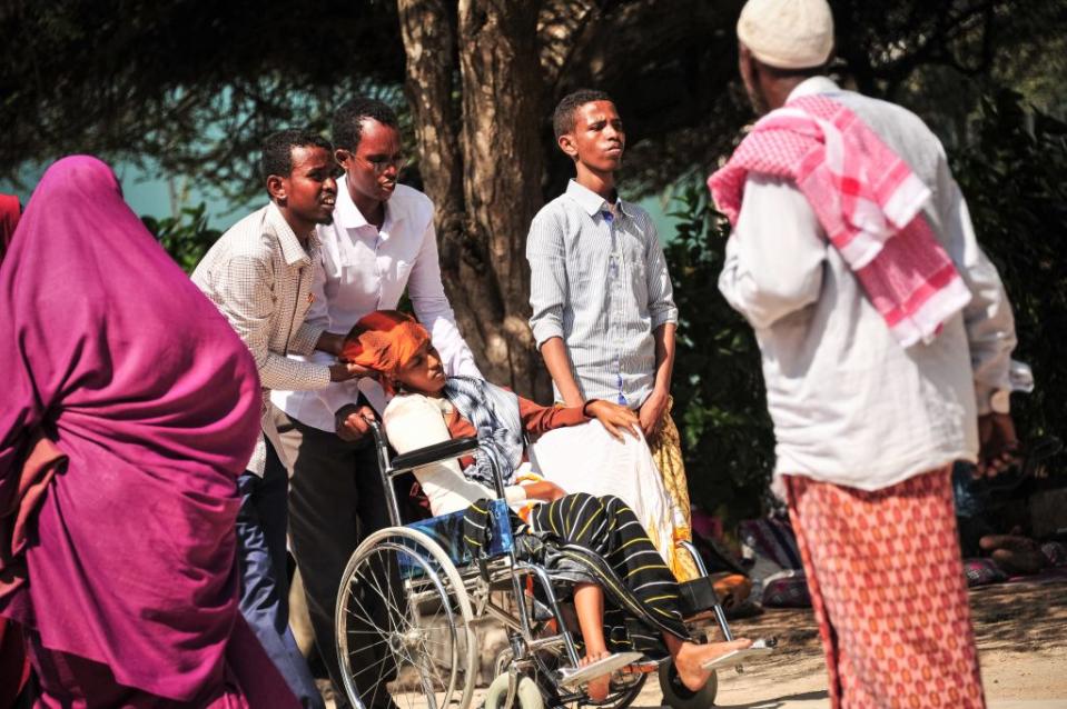 People crowd round the injured