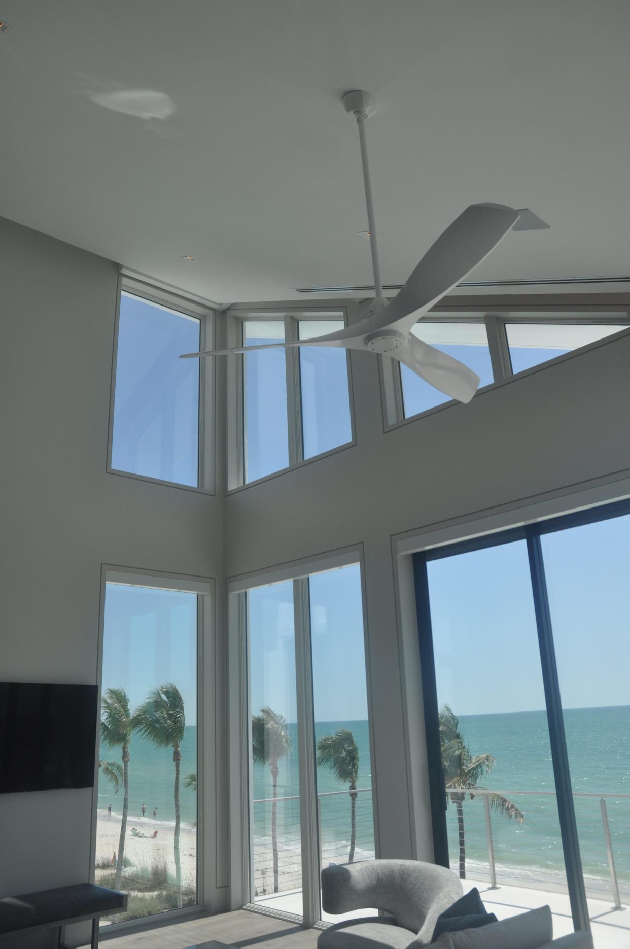 Sloping ceilings are prevalent in the top story of the home. They take the shape from the sails on the roof. Lots of windows bring in tremendous natural light.