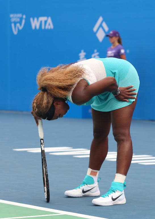 Serena Williams of the US reacts during her match against France's Alize Cornet at Wuhan Open tennis tournament in Wuhan, in China's Hubei province on September 23, 2014