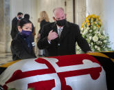 Gov. Larry Hogan, center, with wife Yumi, left, pays respects to the late Senate President Emeritus Thomas V. Mike Miller, Jr., under the dome of the statehouse at the Maryland Statehouse in Annapolis, Md., on Friday, Jan. 22, 2021. Miller was a state legislator for 50 years. A Democrat, he served as president of the Maryland Senate for 33 years. He announced he was stepping down from the post in 2019, but he remained a senator until December. (Bill O'Leary/The Washington Post via AP, Pool)