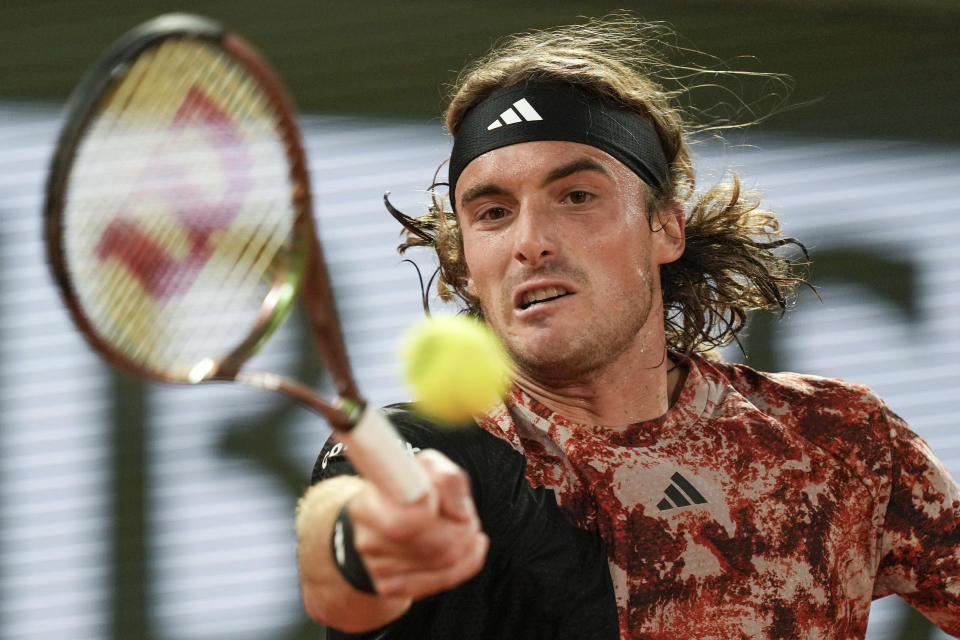 FILE - Greece's Stefanos Tsitsipas plays a shot against Spain's Carlos Alcaraz during their quarterfinal match of the French Open tennis tournament at Roland Garros stadium in Paris, Tuesday, June 6, 2023. Tsitsipas is expected to compete at Wimbledon next week. (AP Photo/Thibault Camus, File)