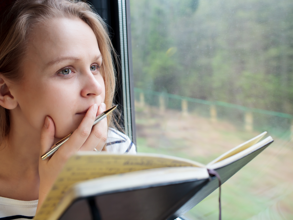 woman writing thinking