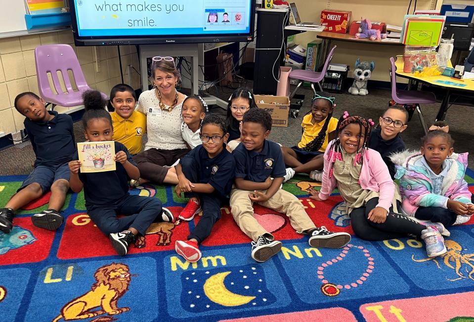Volunteer Kirsten Russell of the Community Foundation of Sarasota County with kindergarten students at Emma E. Booker Elementary in Sarasota during EOD's annual “Bucket Fillers” event.
