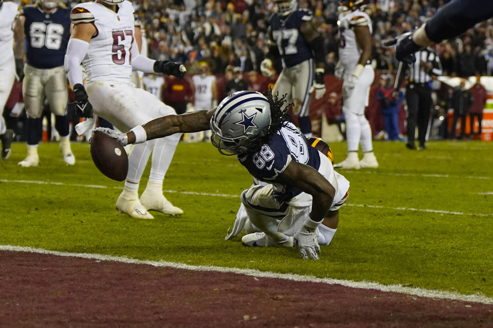 Dallas Cowboys wide receiver CeeDee Lamb (88) extends his arm to score a touchdown against the Washington Commanders during the first half of an NFL football game, Sunday, Jan. 7, 2024, in Landover, Md. (AP Photo/Jessica Rapfogel)